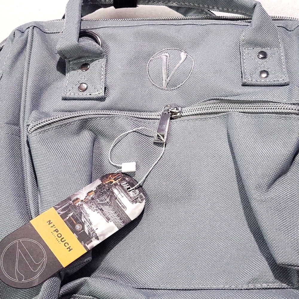 Silver Gray Canvas Backpack with Structured Design and Yellow Tag